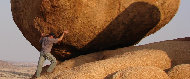 Demonstrating strengths by fake lifiing or moving a rock